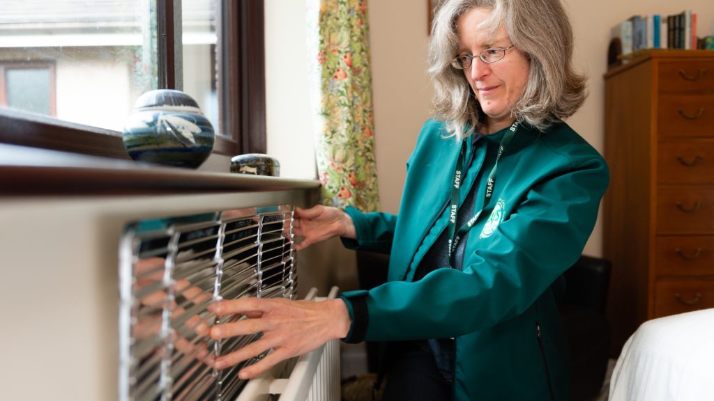 Fitting a radiator reflector Cold to Cosy Homes Cumbria