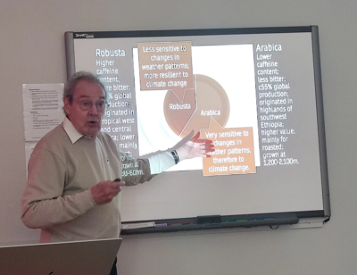 A man presenting in front of a whiteboard